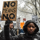People carry signs addressing the issue of sexual harassment at a #MeToo rally outside Trump International Hotel in New York City on Dec. 9, 2017. (Stephanie Keith/Getty Images)